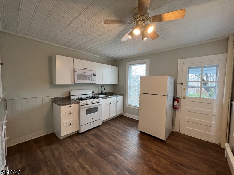 193 Forest Street, Unit 1 Montclair, NJ 07042 - Photo 6 of 20 a kitchen with wooden floors and white appliances