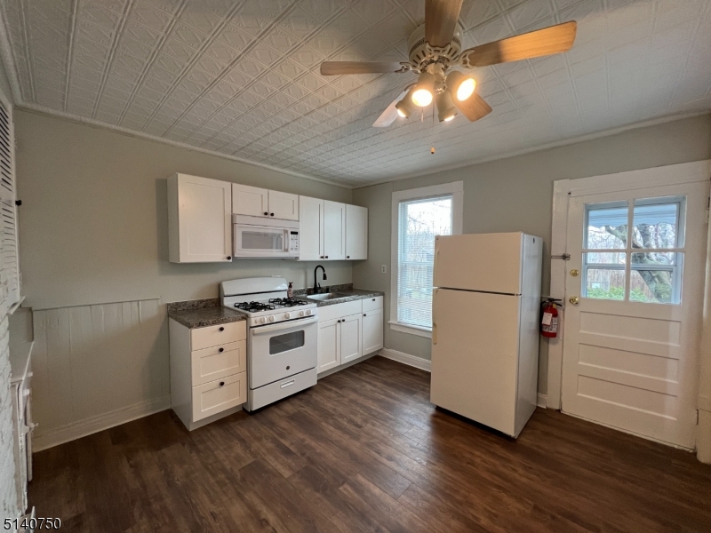 193 Forest Street, Unit 1 Montclair, NJ 07042 - Photo 8 of 20 a kitchen with cabinets stainless steel appliances a sink and a window
