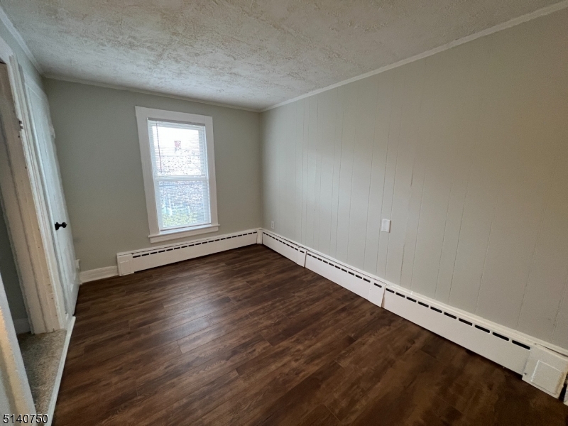 193 Forest Street, Unit 1 Montclair, NJ 07042 - Photo 9 of 20 an empty room with wooden floor and windows