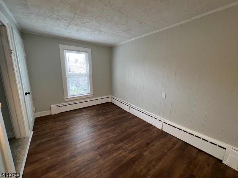 193 Forest Street, Unit 1 Montclair, NJ 07042 - Photo 10 of 20 an empty room with wooden floor and windows