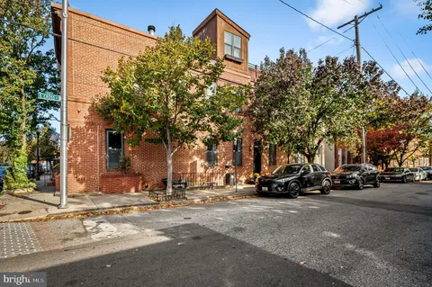 a row of palm trees in front of a building