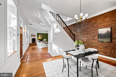 a dining room with furniture and chandelier