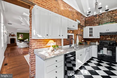 a kitchen with granite countertop stainless steel appliances a stove a sink and a refrigerator