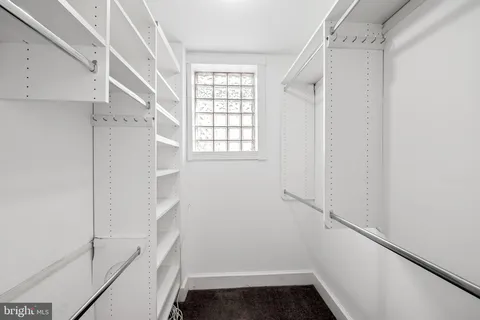 a view of hallway with stairs and wooden floor