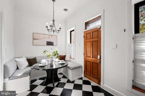 a dining room with furniture and window