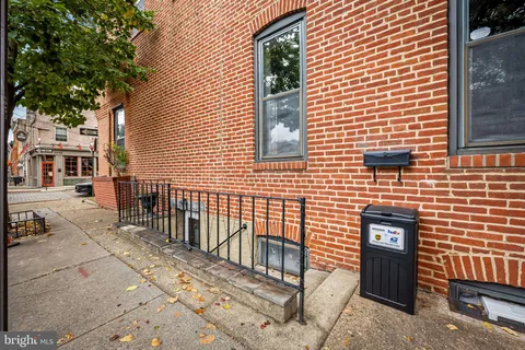 a view of a brick house with many windows