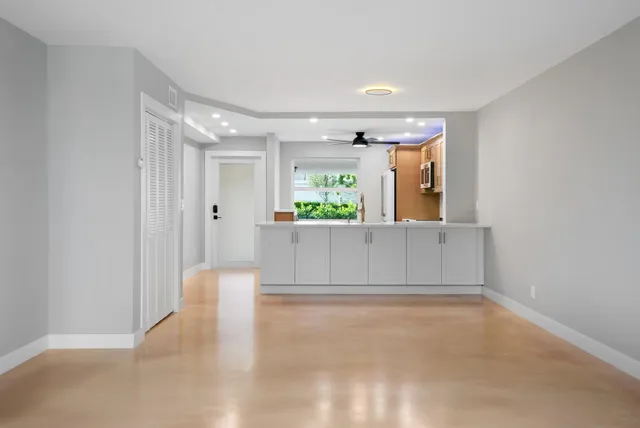 a bathroom with a bathtub shower sink mirror vanity and toilet
