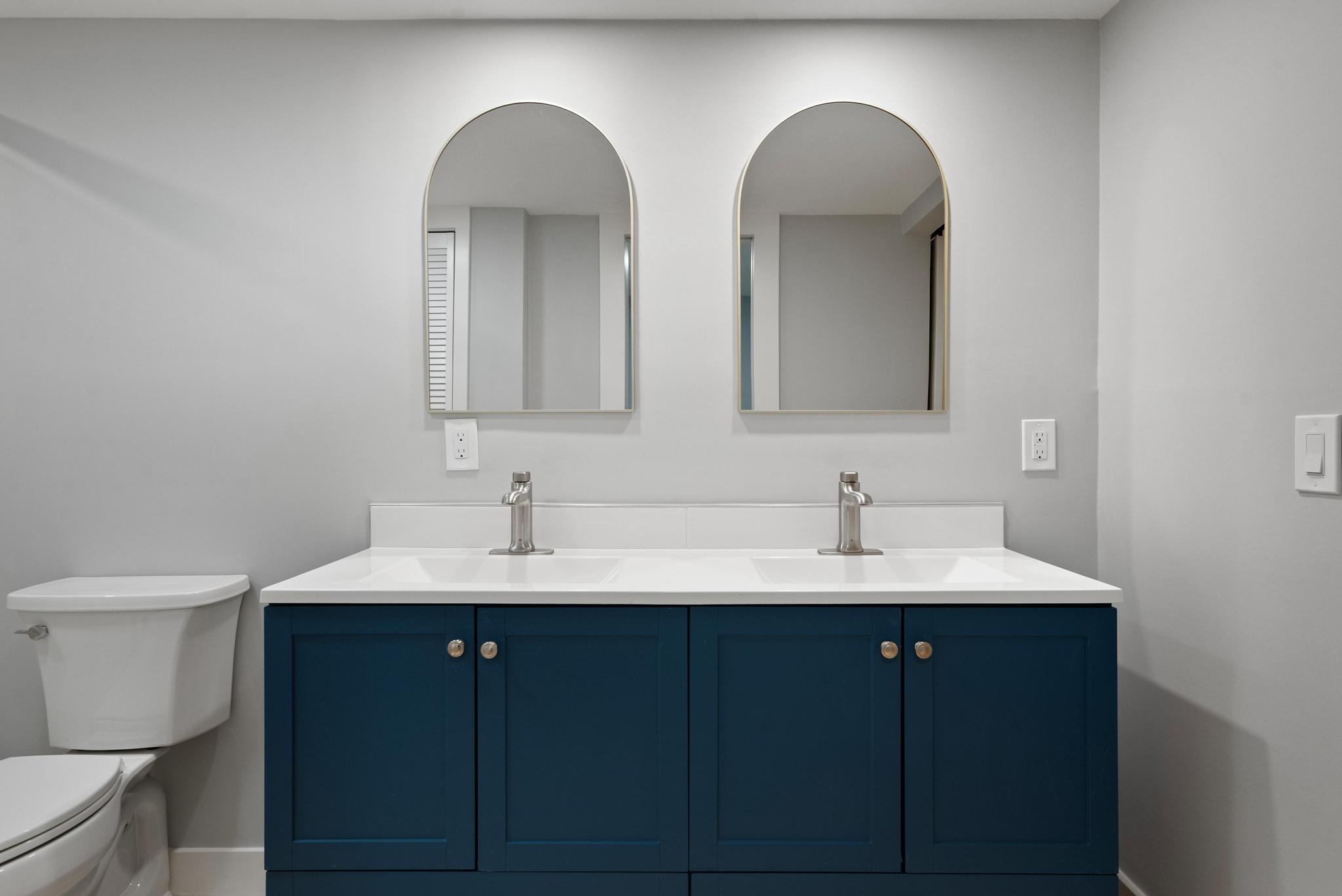 2525 Florida Boulevard, Unit 127 Delray Beach, FL 33483 - Photo 23 of 62 a bathroom with 2 sink and a toilet