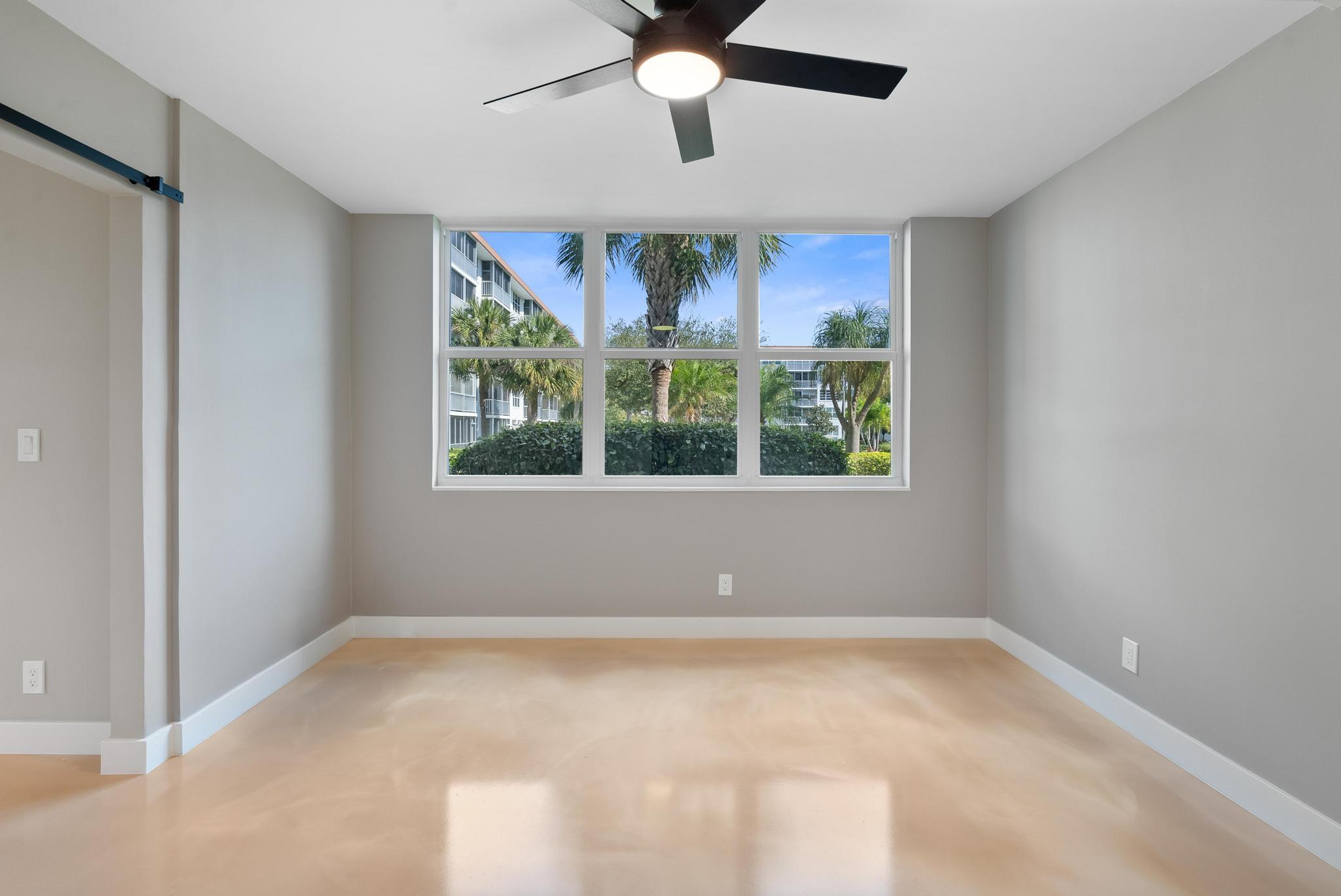 2525 Florida Boulevard, Unit 127 Delray Beach, FL 33483 - Photo 28 of 62 an empty room with a window and a ceiling fan