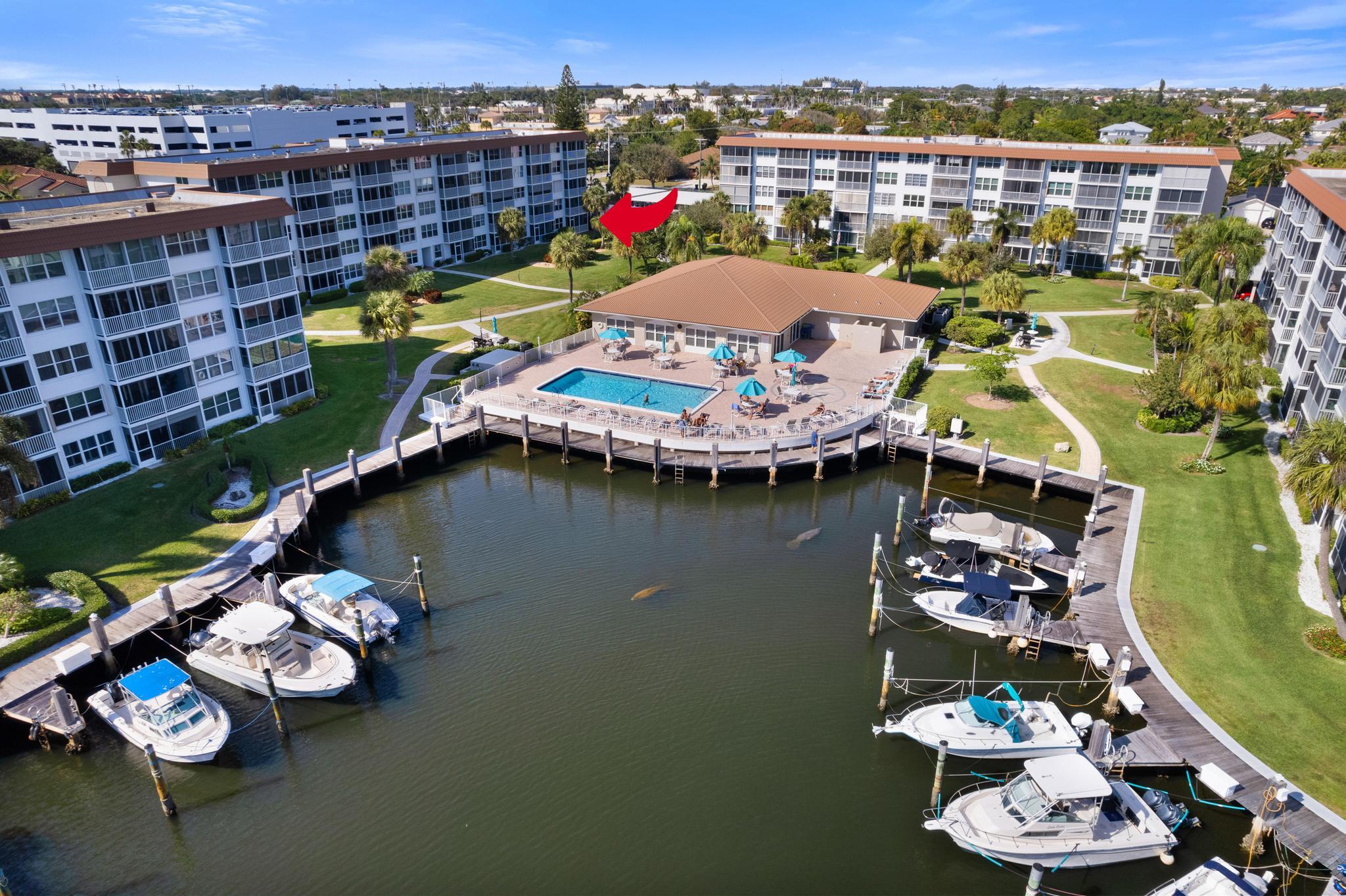 2525 Florida Boulevard, Unit 127 Delray Beach, FL 33483 - Photo 3 of 62 an aerial view of a house with swimming pool and outdoor seating