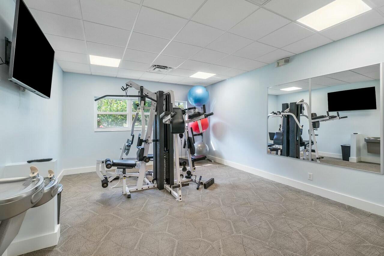 2525 Florida Boulevard, Unit 127 Delray Beach, FL 33483 - Photo 43 of 62 a view of a room with gym equipment and a flat screen tv