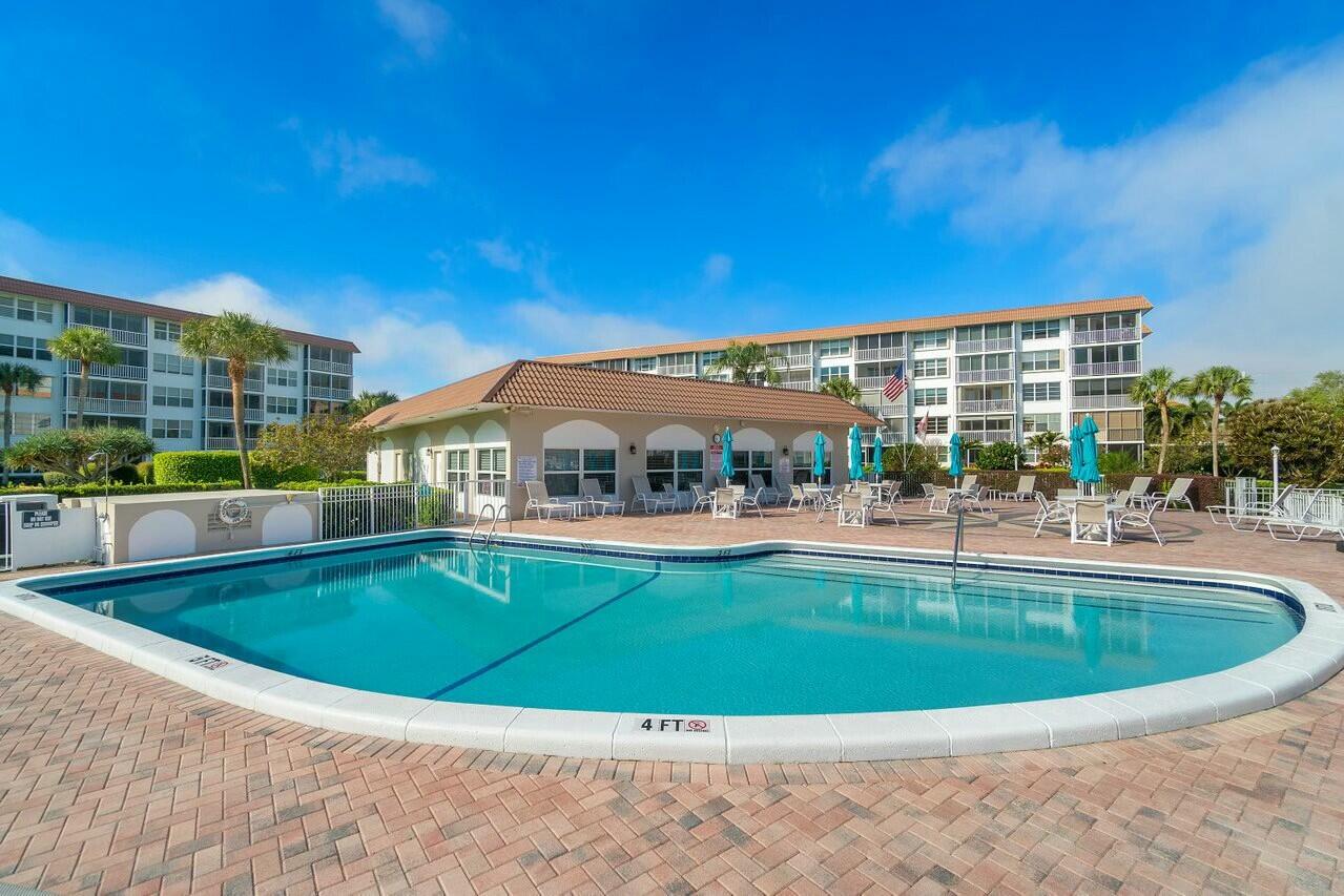 2525 Florida Boulevard, Unit 127 Delray Beach, FL 33483 - Photo 46 of 62 a view of a swimming pool with a patio