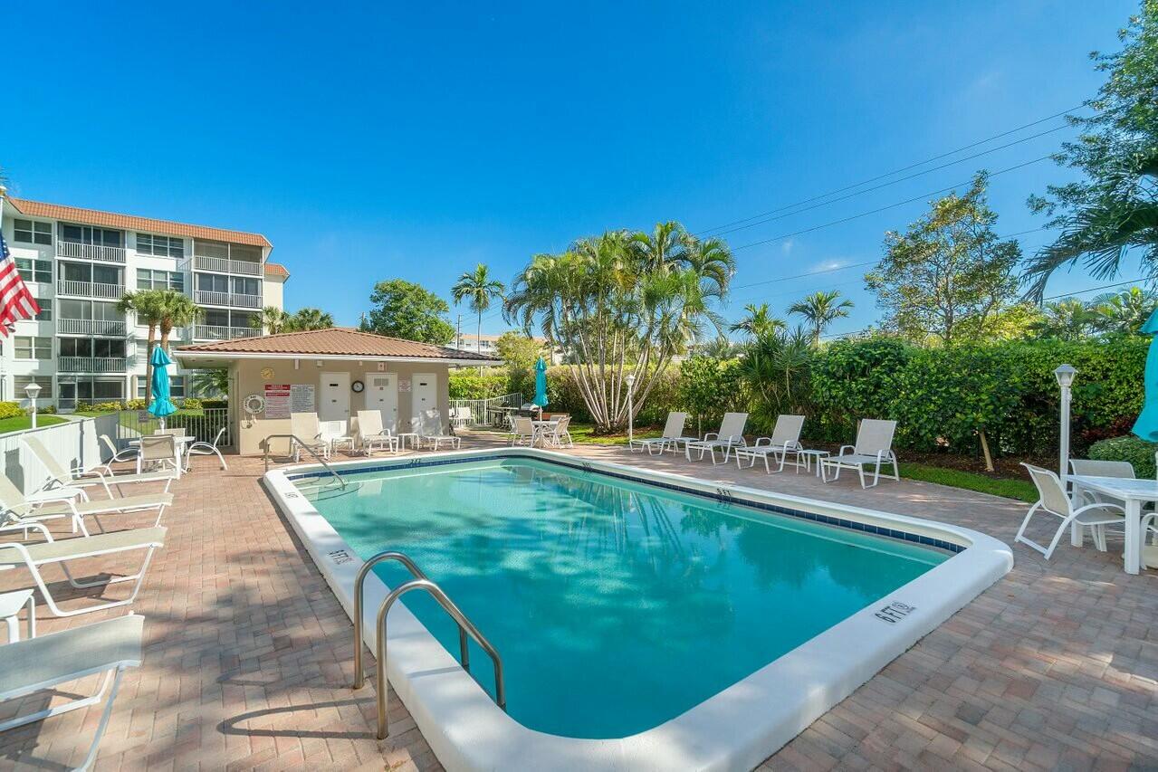 2525 Florida Boulevard, Unit 127 Delray Beach, FL 33483 - Photo 48 of 62 a view of a swimming pool with an outdoor seating