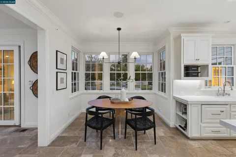 a dining room with furniture and window