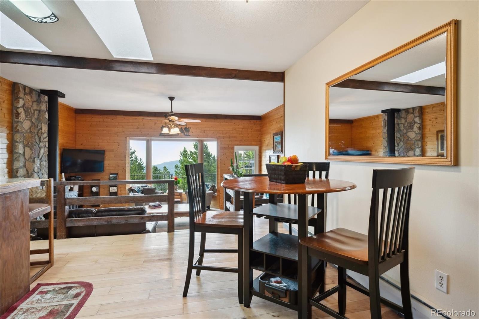 11094 Thomas Drive Conifer, CO 80433 - Photo 13 of 44 a dining room with furniture and a large window