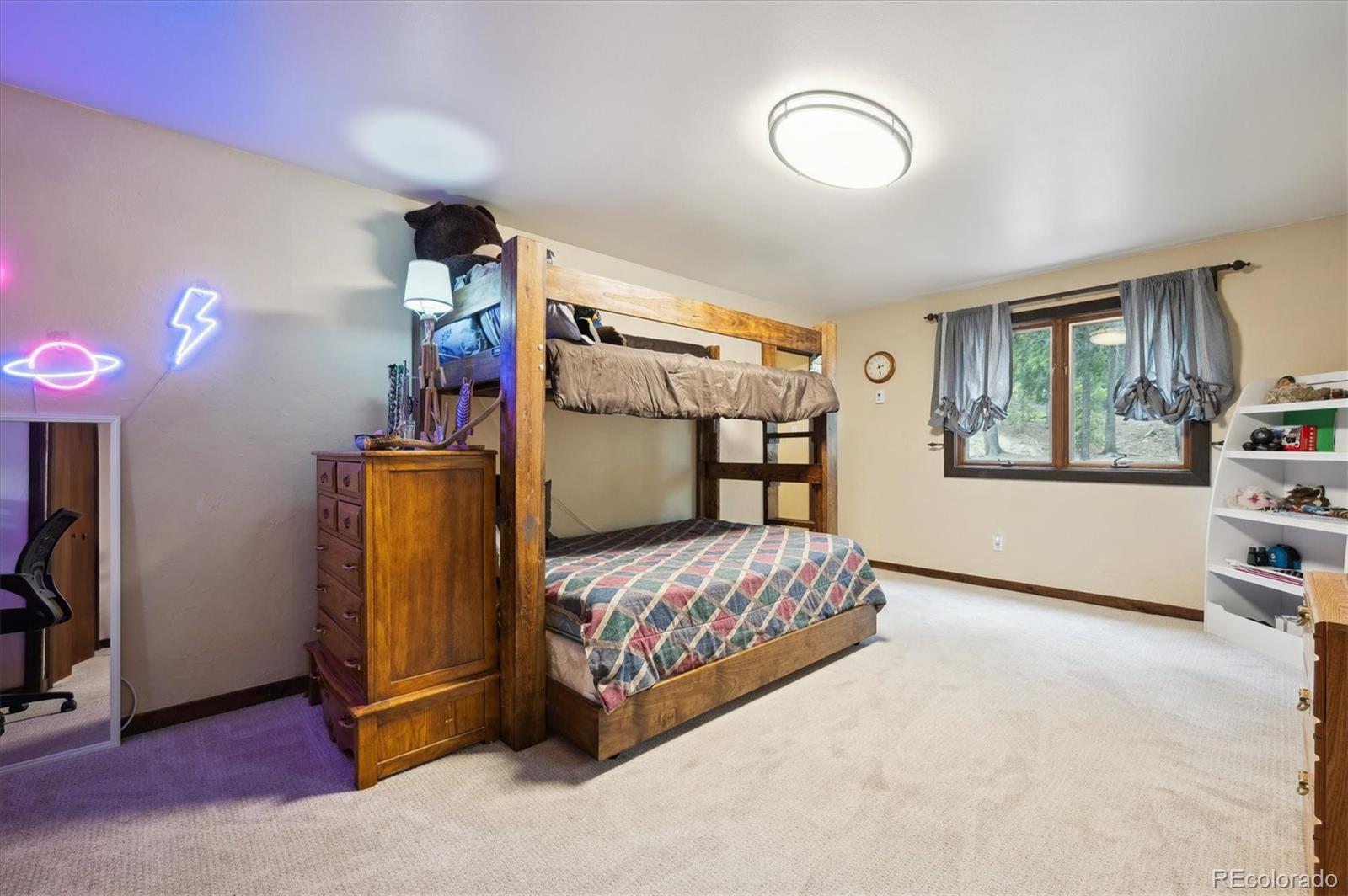11094 Thomas Drive Conifer, CO 80433 - Photo 23 of 44 a bedroom with a bed and a window