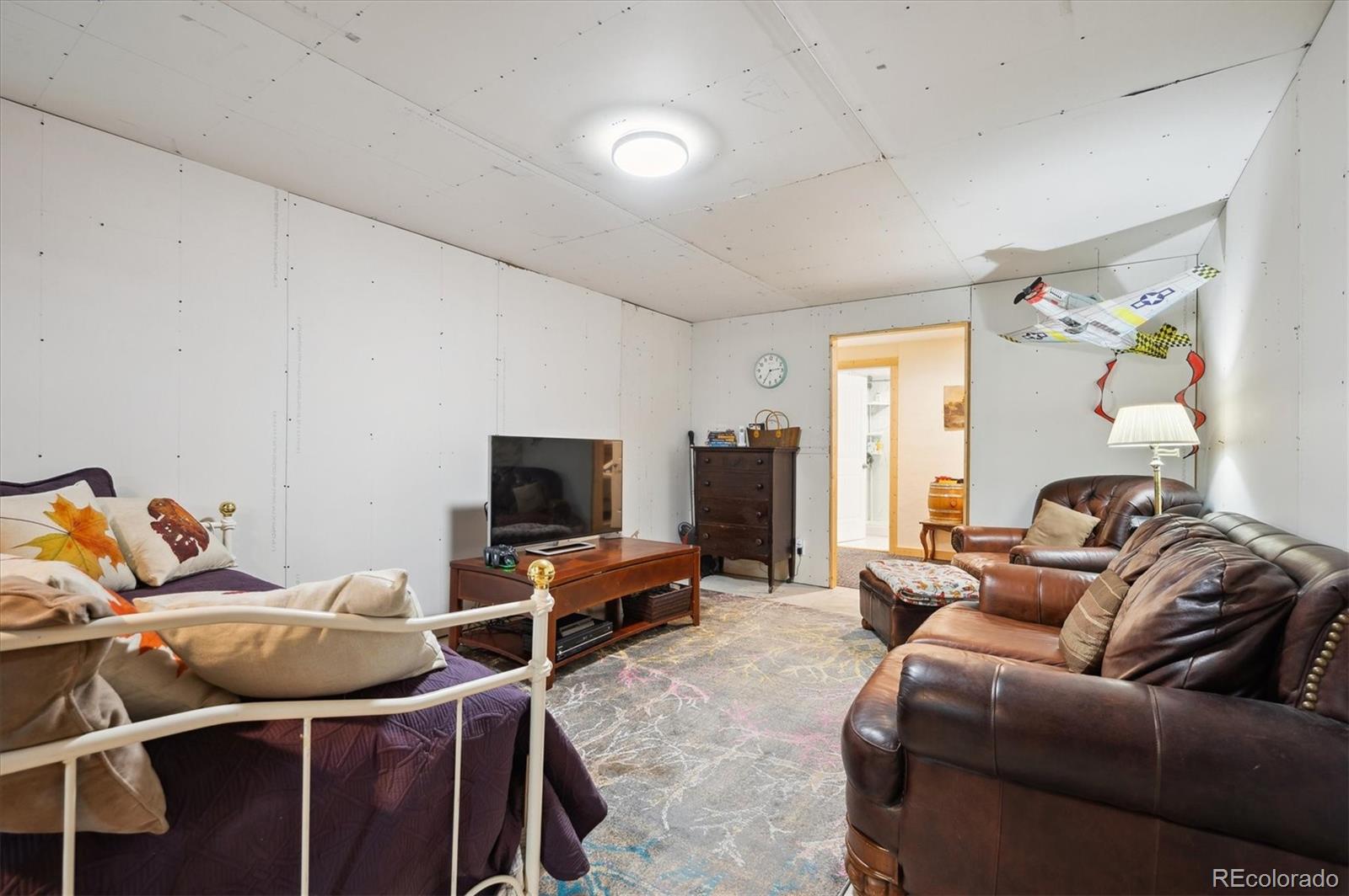 11094 Thomas Drive Conifer, CO 80433 - Photo 25 of 44 a living room with furniture and a flat screen tv