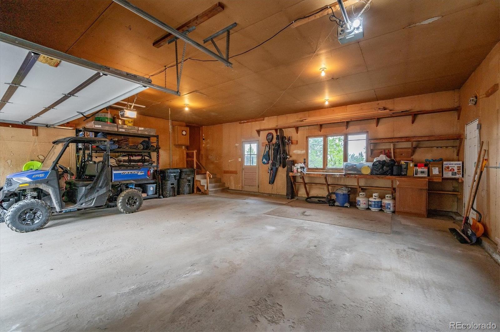 11094 Thomas Drive Conifer, CO 80433 - Photo 41 of 44 a view of a garage with parked cars