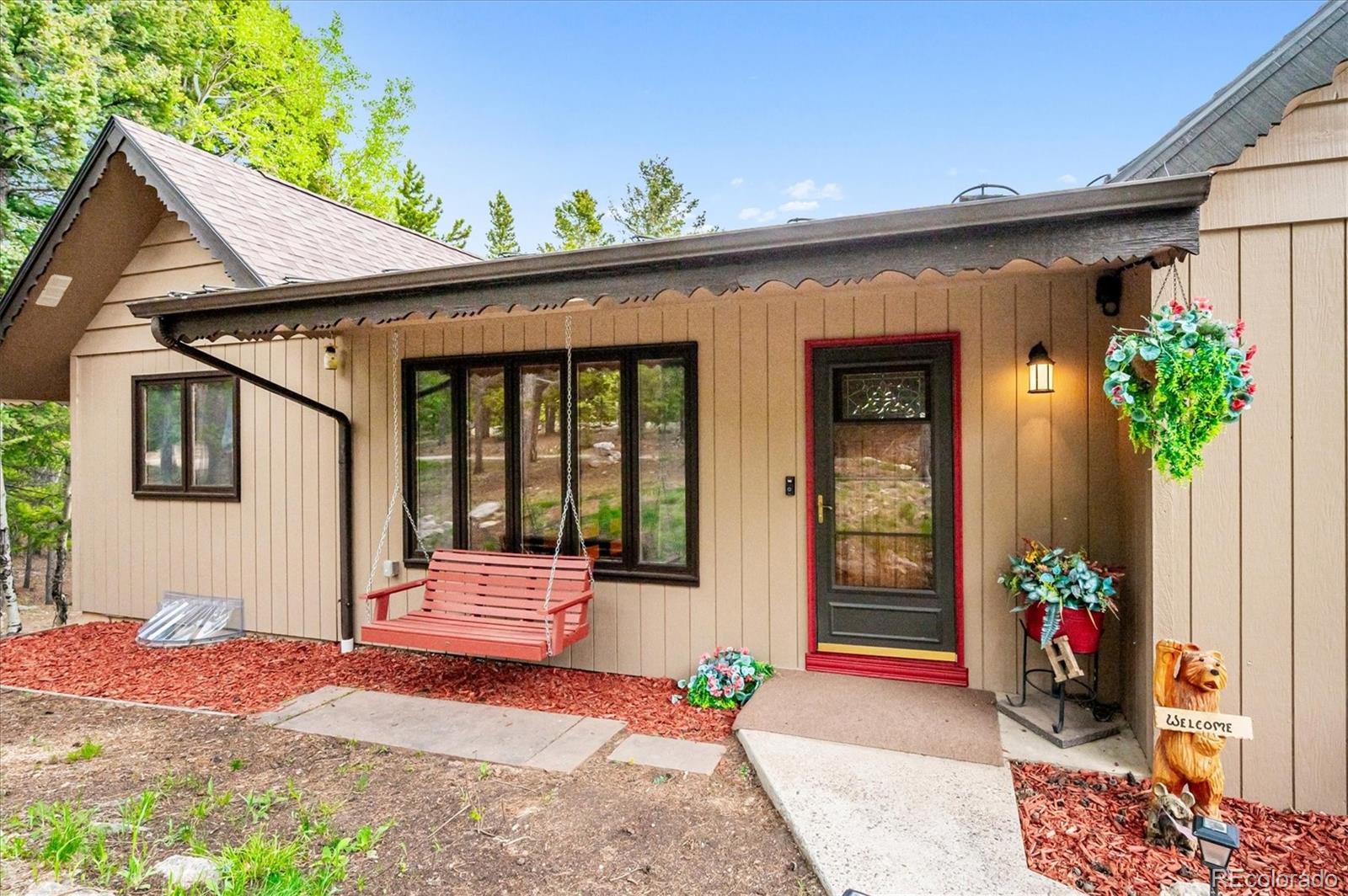 11094 Thomas Drive Conifer, CO 80433 - Photo 6 of 44 a front view of a house with a porch
