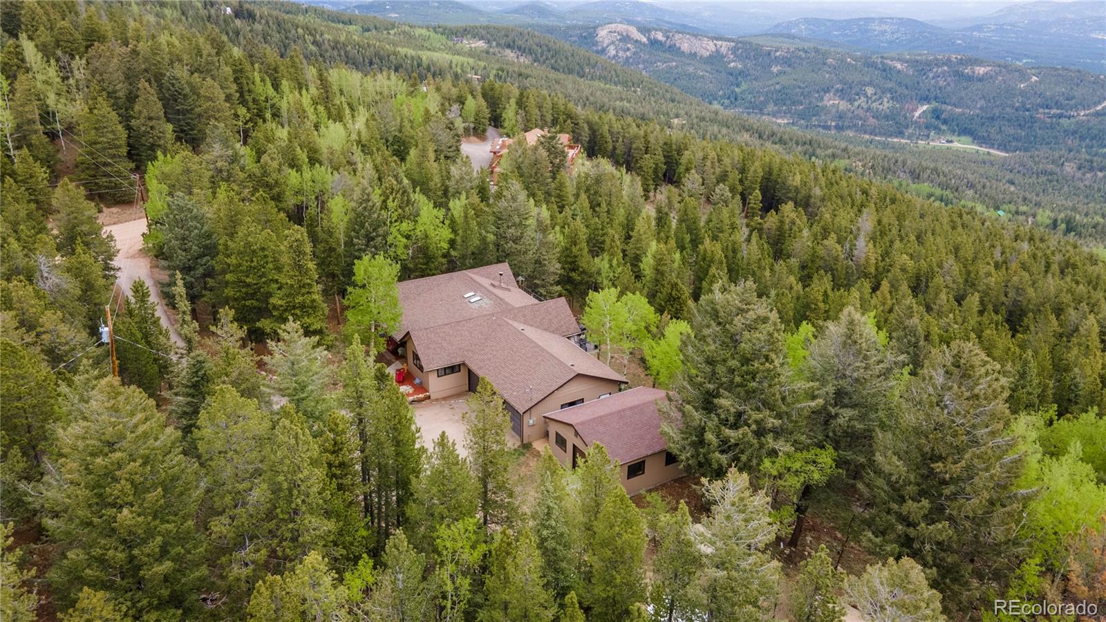 11094 Thomas Drive Conifer, CO 80433 - Photo 8 of 44 an aerial view of residential houses with outdoor space and trees