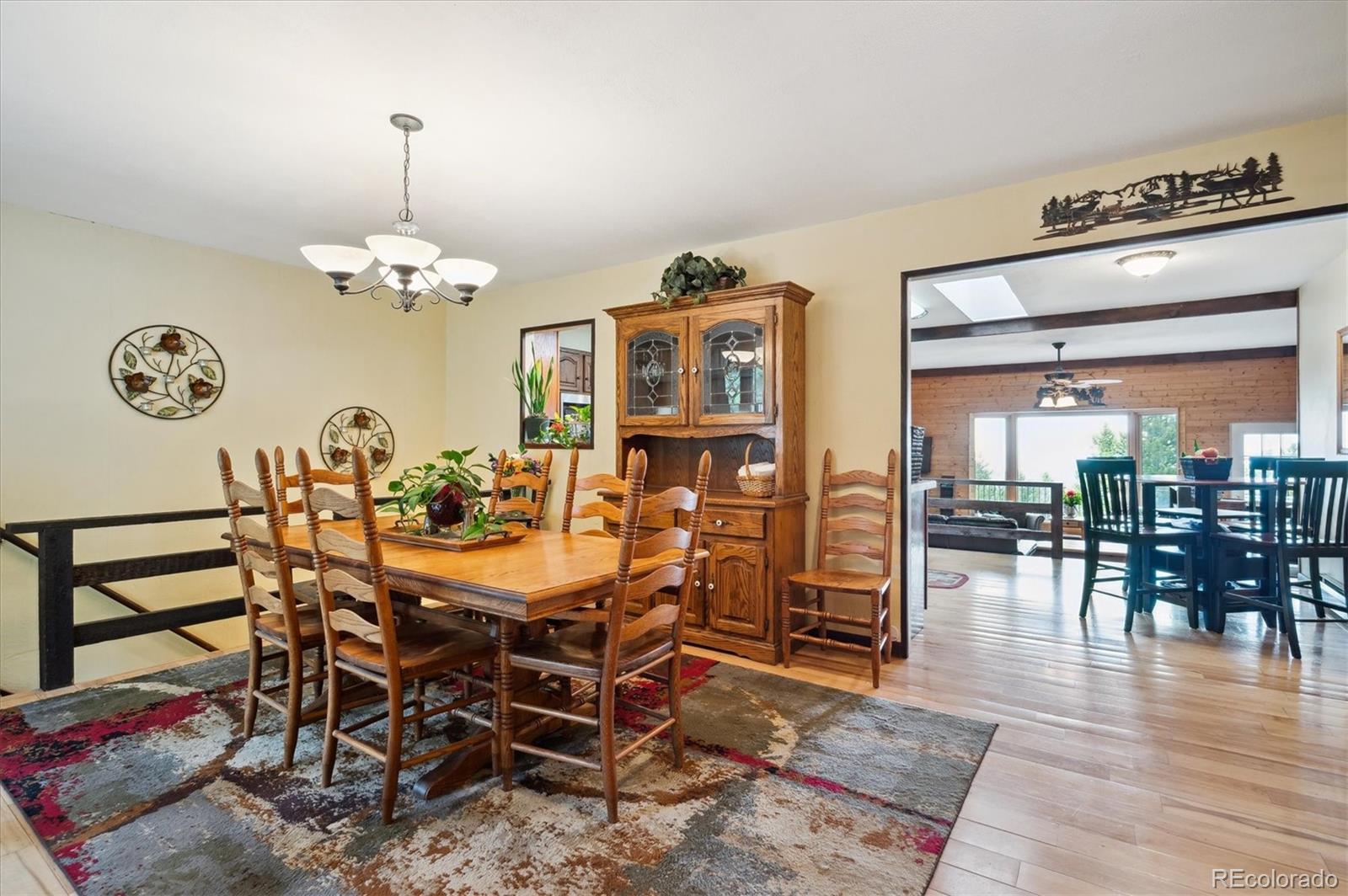 11094 Thomas Drive Conifer, CO 80433 - Photo 9 of 44 a view of a dining room with furniture wooden floor and chandelier