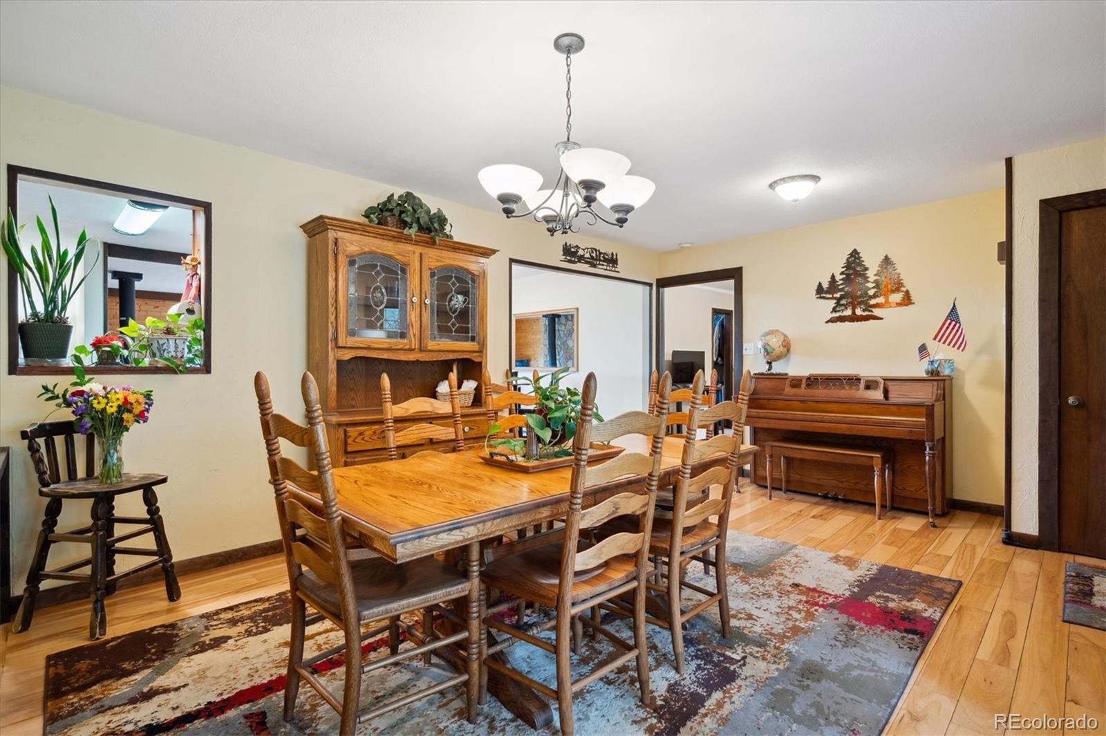 11094 Thomas Drive Conifer, CO 80433 - Photo 10 of 44 a view of a dining room with furniture and a chandelier