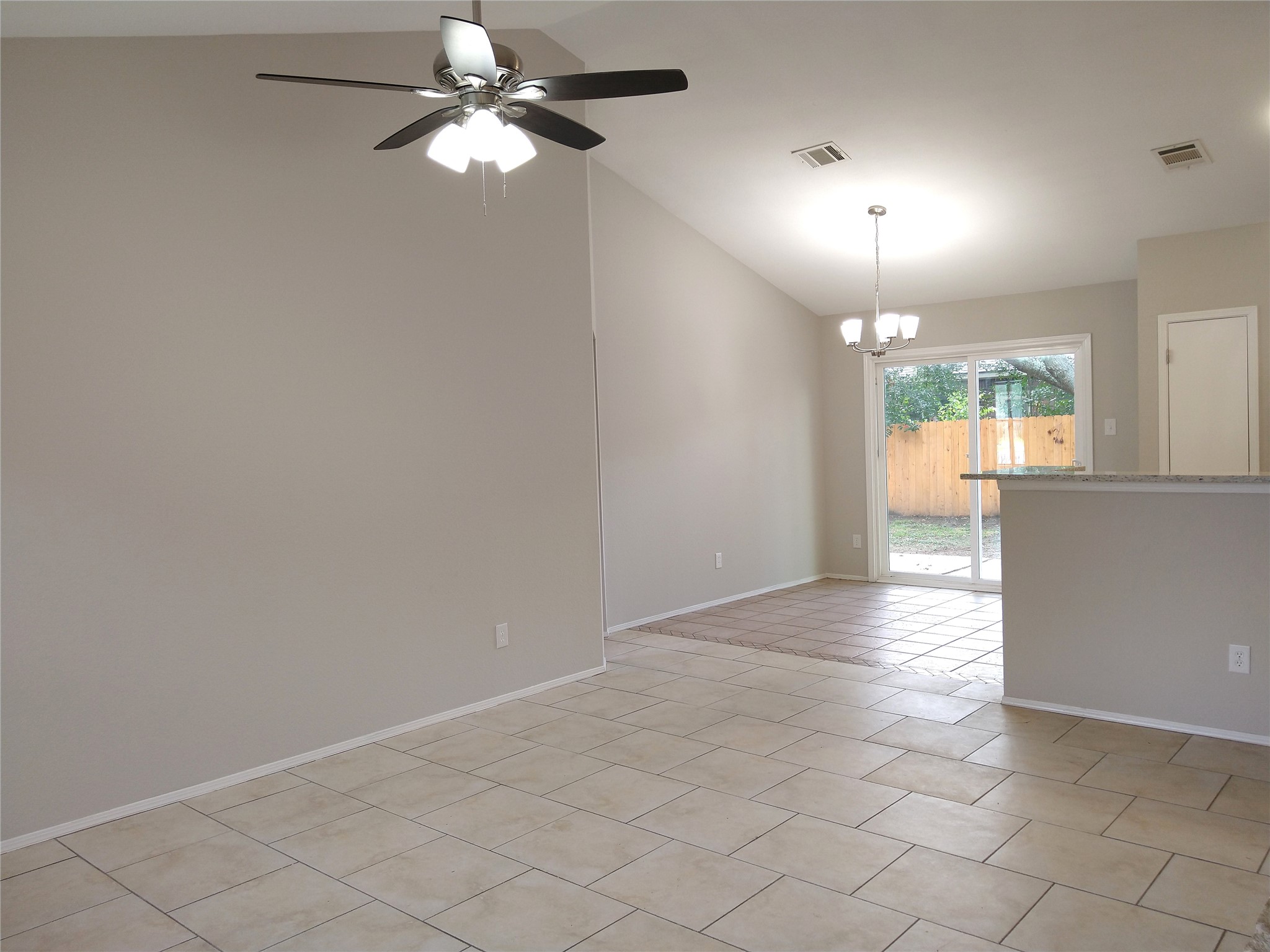 1813 Laurel Path Round Rock, TX 78664 - Photo 5 of 35 A versatile open-concept living area boasts vaulted ceilings and direct yard access.