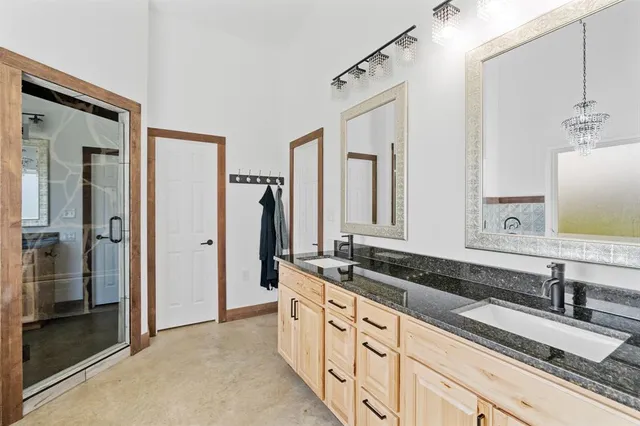 a spacious bathroom with double sink and a mirror