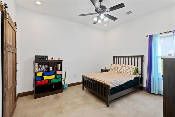 a bedroom with a bed and a table in it