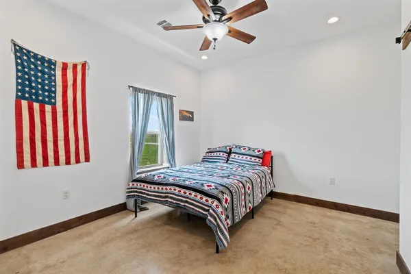 a bedroom with a bed and a window
