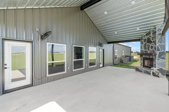 a view of a house with wooden floor and a ceiling fan