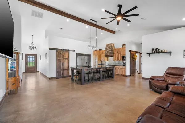 a living room with furniture and kitchen view