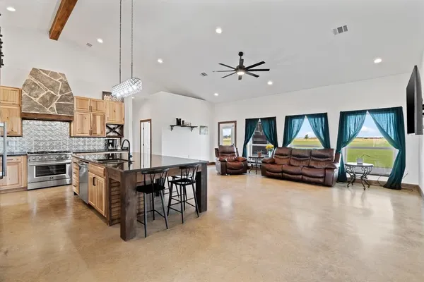 a living room with furniture and kitchen view
