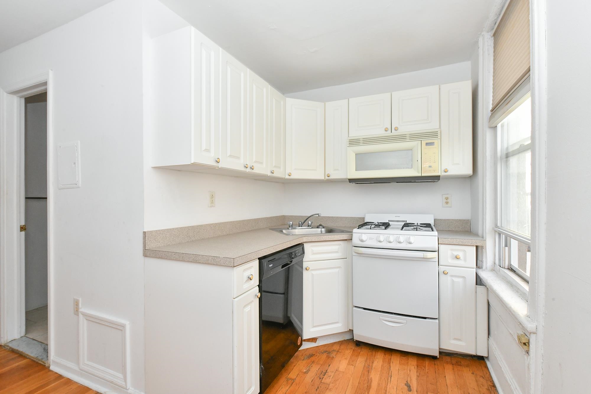 409 Bloomfield Street, Unit 7 Hoboken, NJ 07030 - Photo 1 of 14 a view of cabinets a sink and a stove in a room