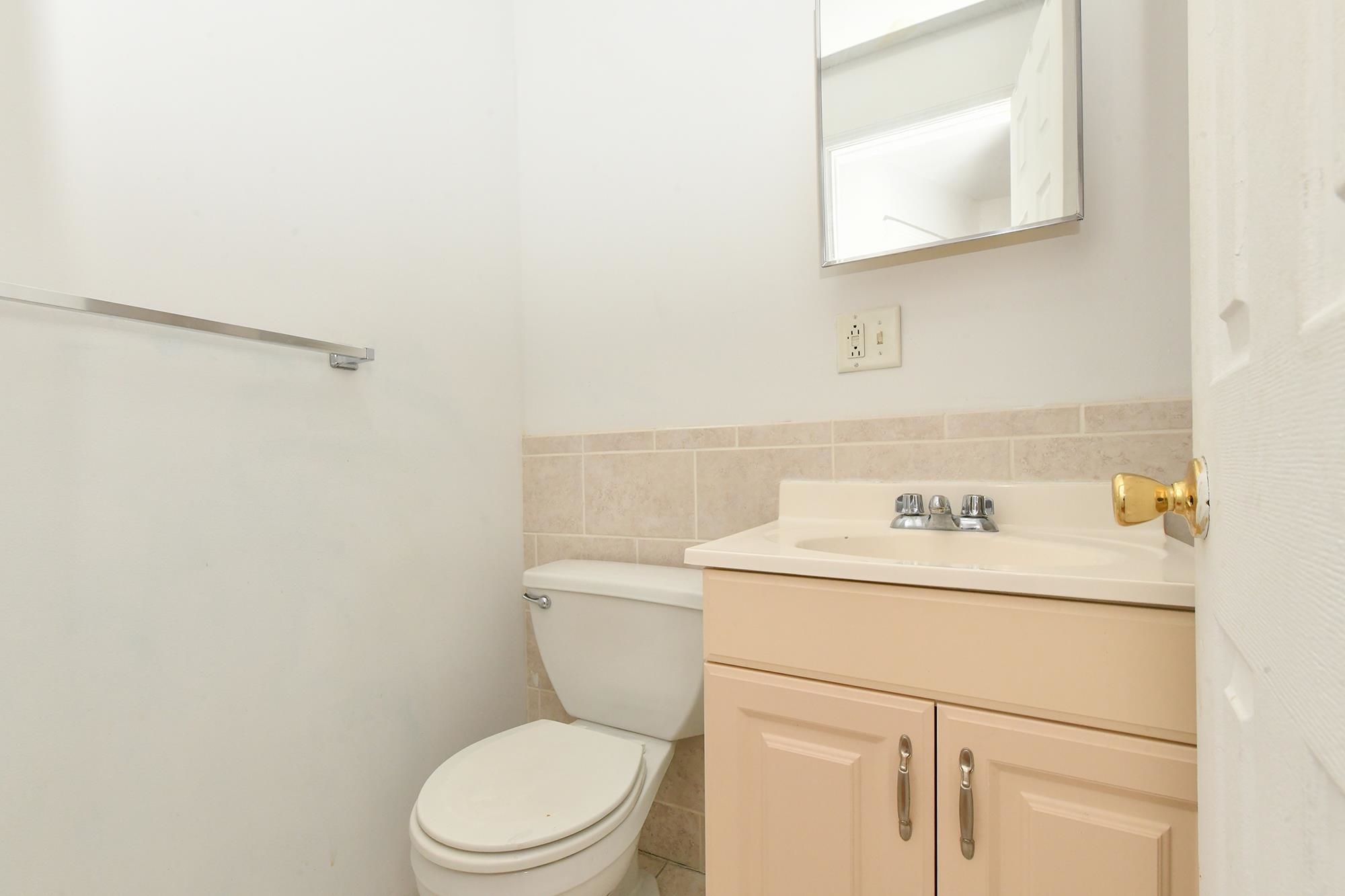 409 Bloomfield Street, Unit 7 Hoboken, NJ 07030 - Photo 12 of 14 a bathroom with a sink a toilet and a mirror
