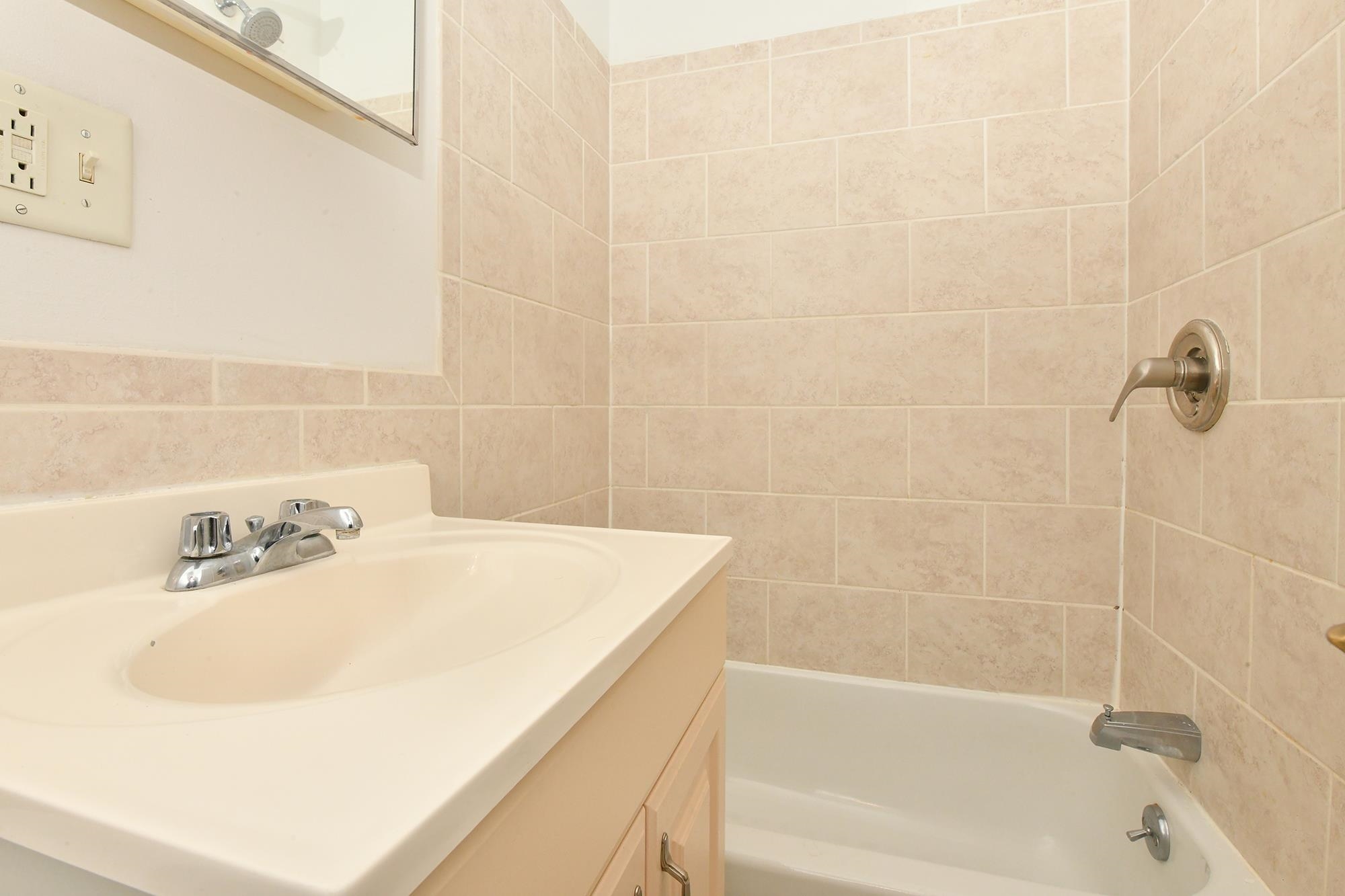 409 Bloomfield Street, Unit 7 Hoboken, NJ 07030 - Photo 13 of 14 a bath tub sitting next to a white sink