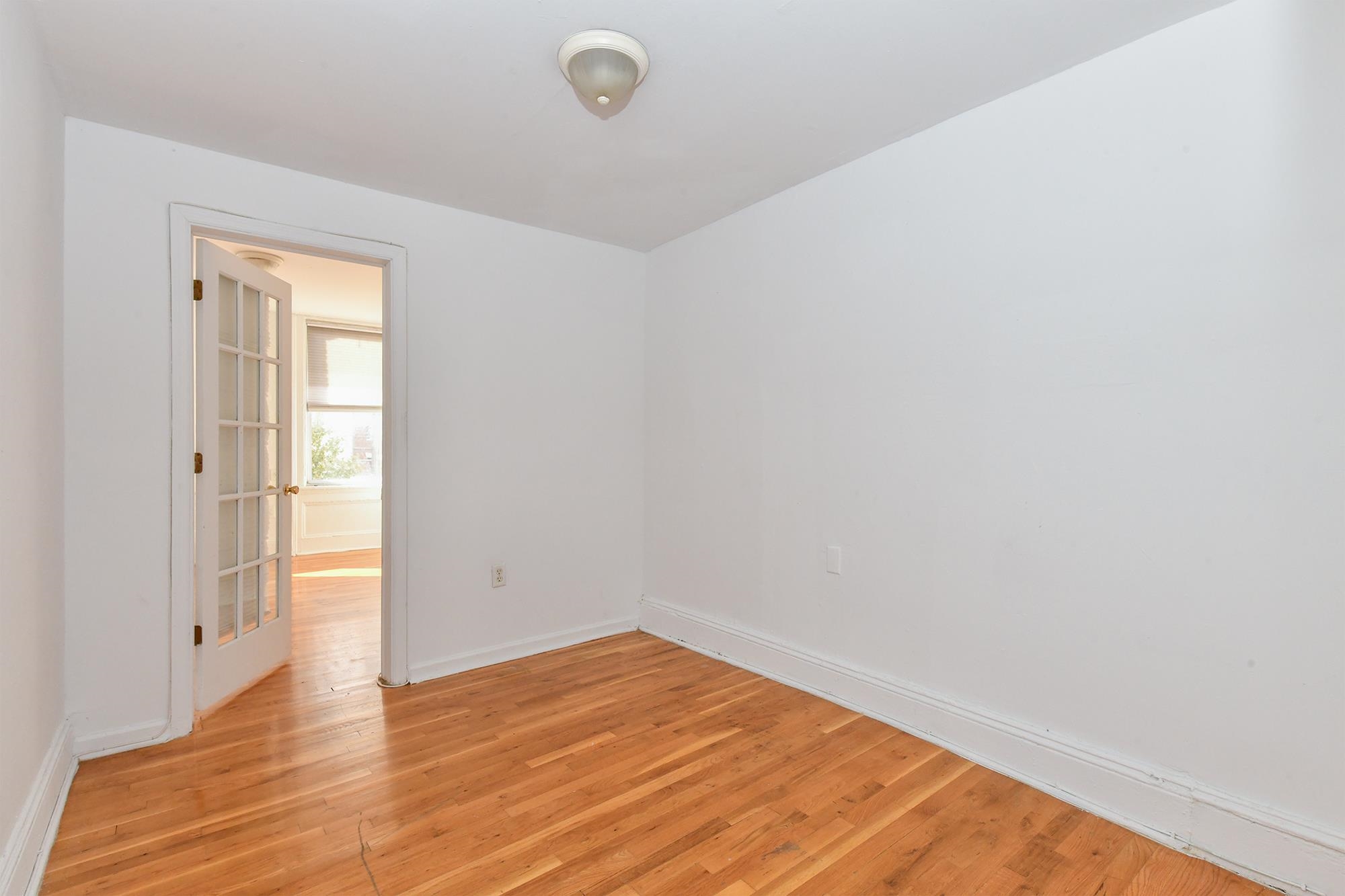 409 Bloomfield Street, Unit 7 Hoboken, NJ 07030 - Photo 5 of 14 a view of empty room with wooden floor