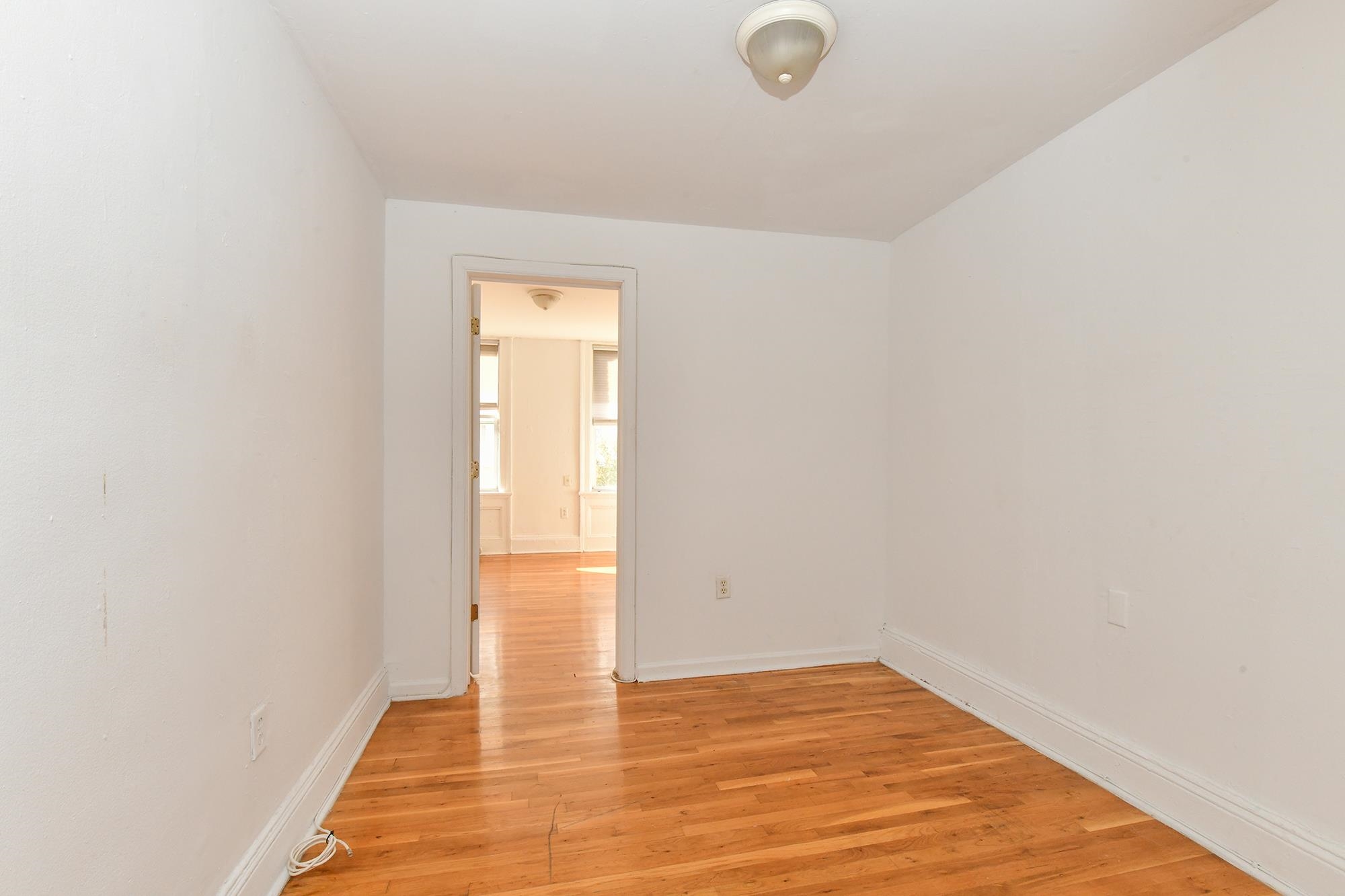 409 Bloomfield Street, Unit 7 Hoboken, NJ 07030 - Photo 6 of 14 a view of an empty room and window