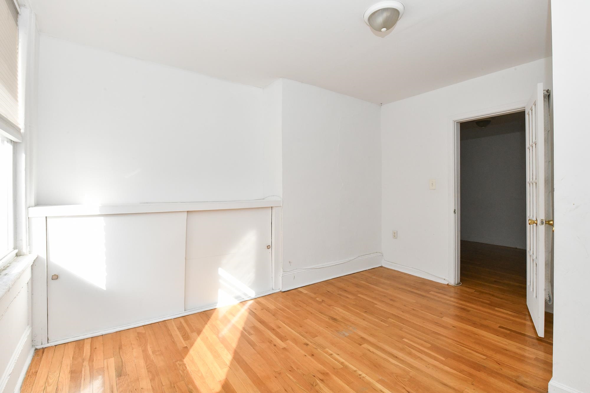 409 Bloomfield Street, Unit 7 Hoboken, NJ 07030 - Photo 10 of 14 a bedroom with a bed and a fan