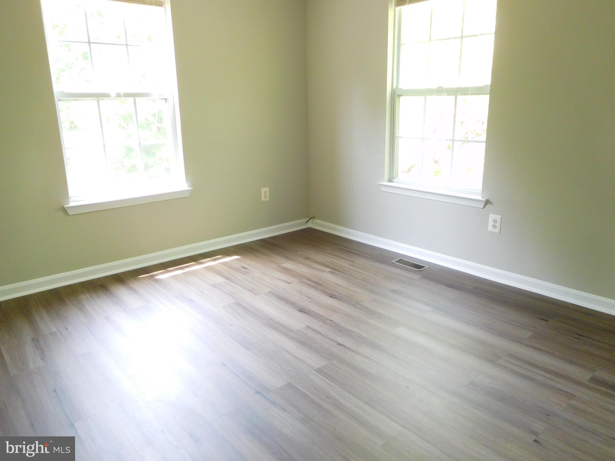 9900 Doubletree Lane Bowie, MD 20721 - Photo 11 of 18 an empty room with wooden floor and windows