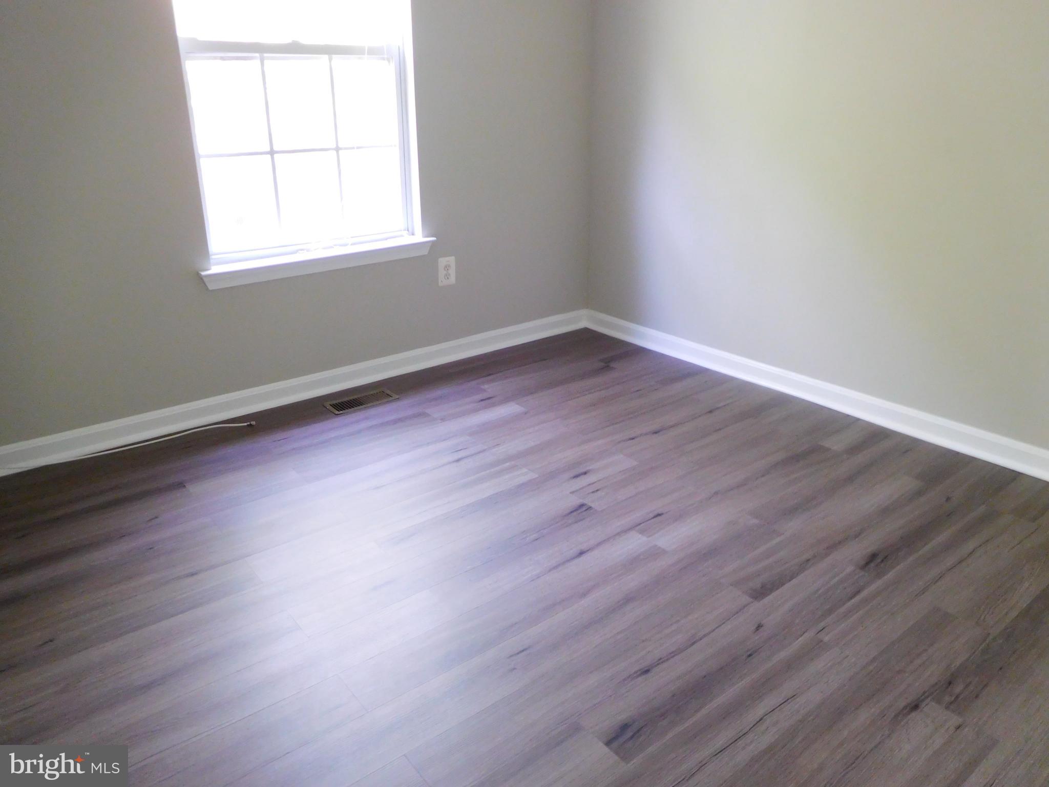 9900 Doubletree Lane Bowie, MD 20721 - Photo 12 of 18 an empty room with wooden floor and windows