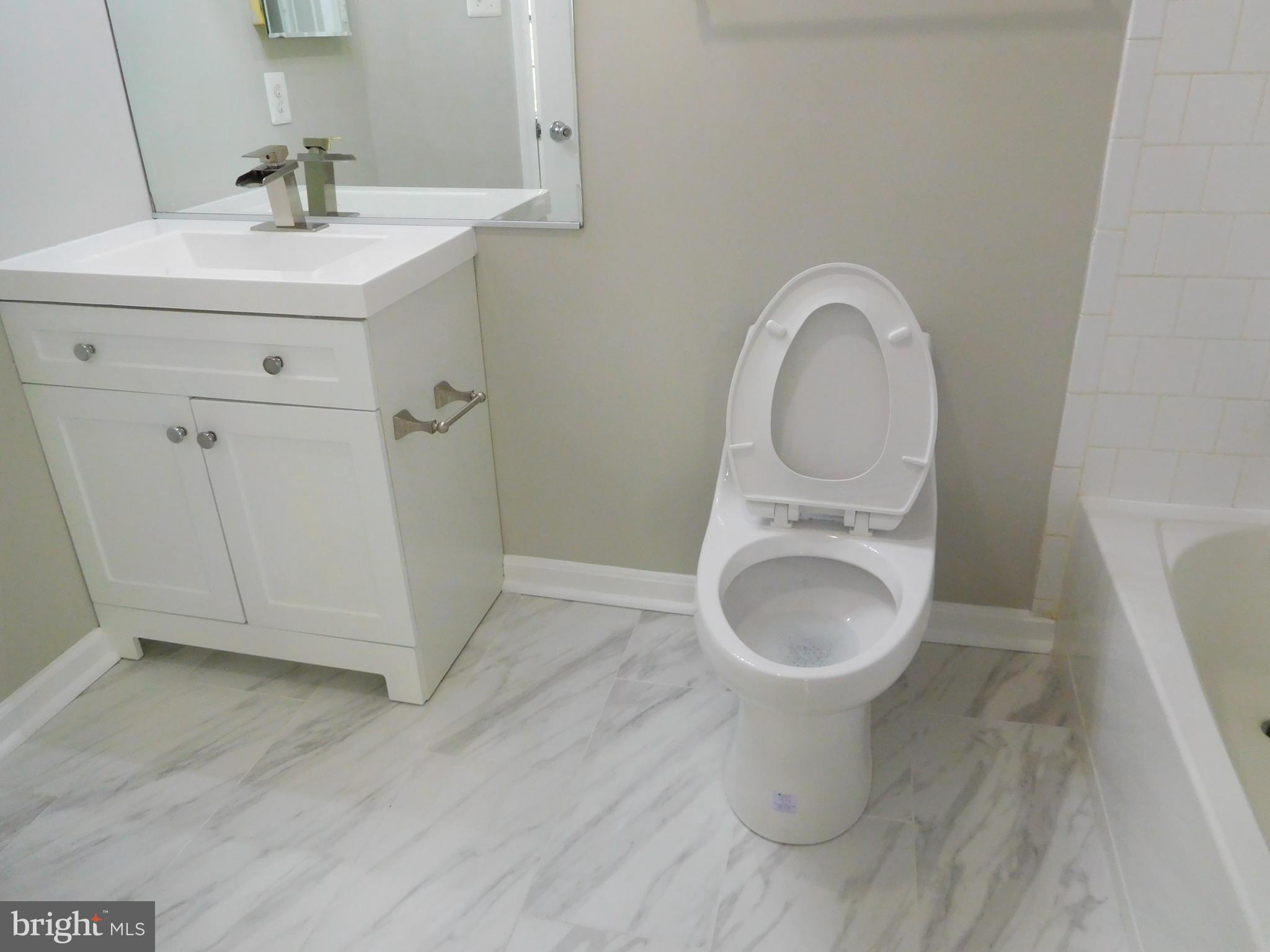 9900 Doubletree Lane Bowie, MD 20721 - Photo 13 of 18 a view of a bathroom with a sink and a toilet