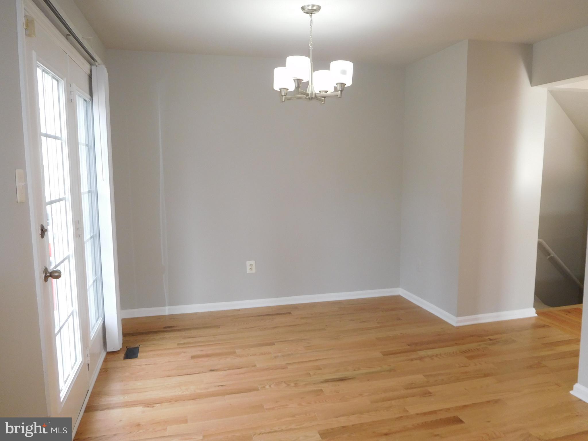 9900 Doubletree Lane Bowie, MD 20721 - Photo 4 of 18 a view of an empty room with wooden floor and a window