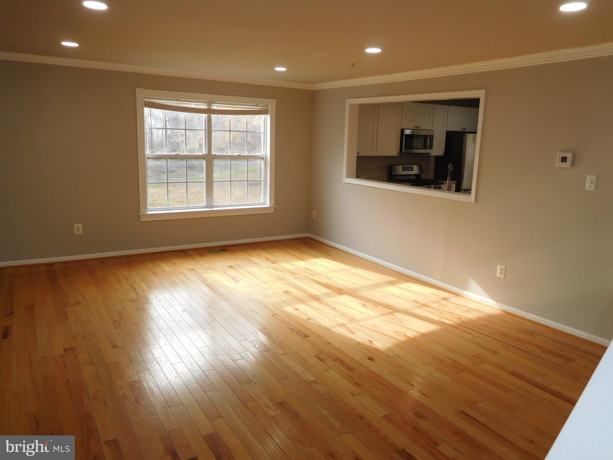 9900 Doubletree Lane Bowie, MD 20721 - Photo 5 of 18 an empty room with wooden floor and windows