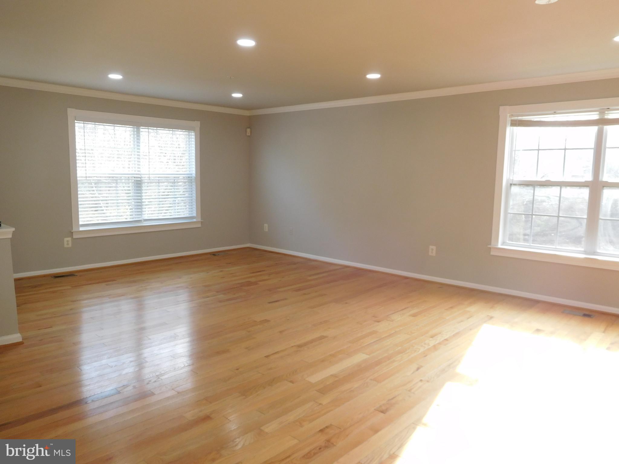 9900 Doubletree Lane Bowie, MD 20721 - Photo 6 of 18 a view of an empty room with wooden floor and a window