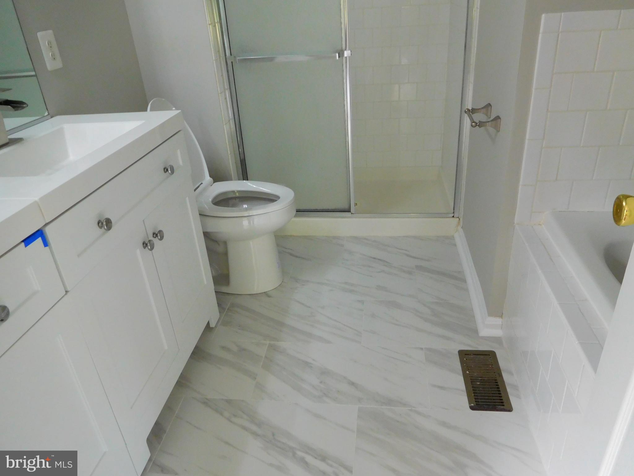 9900 Doubletree Lane Bowie, MD 20721 - Photo 8 of 18 a white toilet sitting next to a bathroom sink