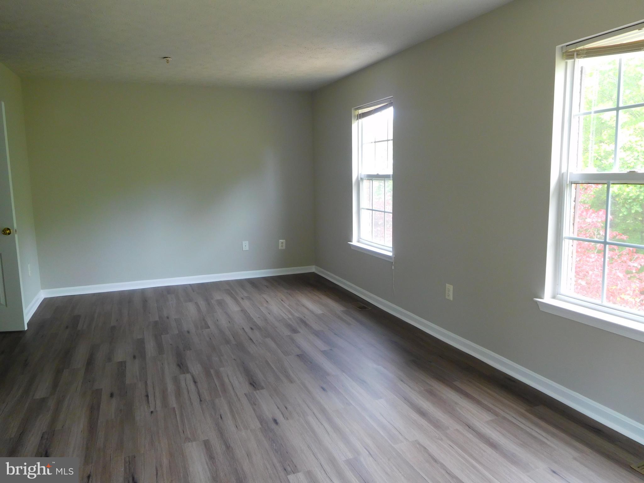 9900 Doubletree Lane Bowie, MD 20721 - Photo 10 of 18 an empty room with wooden floor and windows