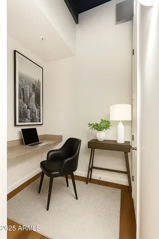 a view of a hallway with wooden floor and closet