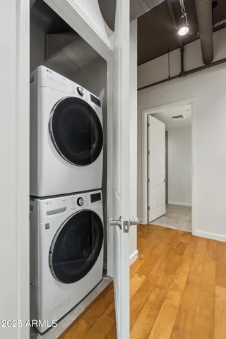 a spacious bathroom with a granite countertop sink a toilet a mirror and shower