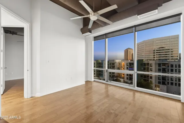 a view of a porch with chairs and floor to ceiling window